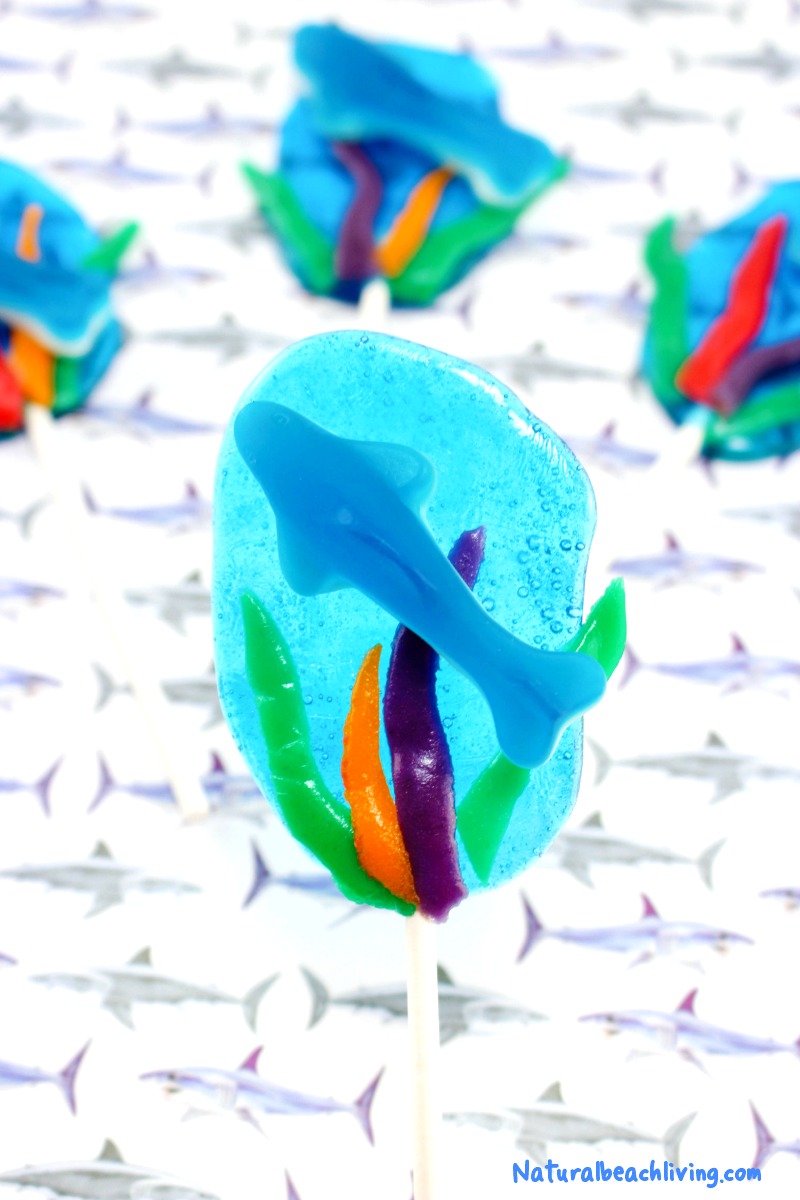 The Best Shark Themed Snacks for Kids, Yummy Shark Suckers or Homemade Shark Lollipops if you prefer for a delicious Shark Week snack idea, So if you are having a Shark theme Party  or looking for Ocean Theme Snacks, these Jolly Rancher Lollipops are an Easy Recipe to make
