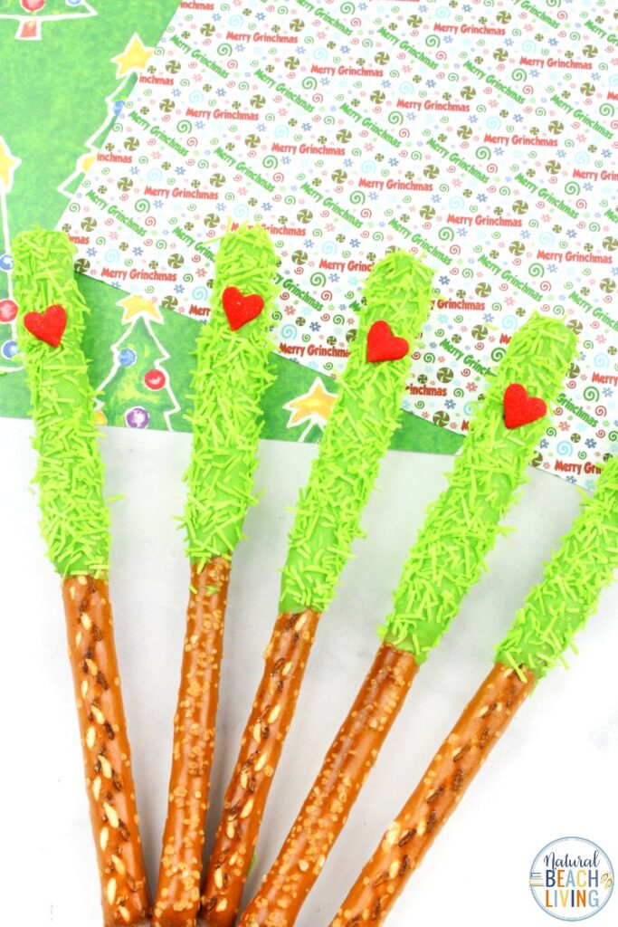 These delicious Grinch Chocolate Covered Pretzels will make everyone happy. They are so easy to make and Grinch Food Recipes look great on a party table. Add these Grinch Chocolate Covered Pretzels to your Grinch Food list and pull off a marvelous movie night or holiday party, Chocolate dipped pretzels, Grinch Party Ideas