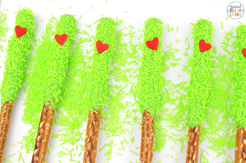 These delicious Grinch Chocolate Covered Pretzels will make everyone happy. They are so easy to make and Grinch Food Recipes look great on a party table. Add these Grinch Chocolate Covered Pretzels to your Grinch Food list and pull off a marvelous movie night or holiday party, Chocolate dipped pretzels, Grinch Party Ideas
