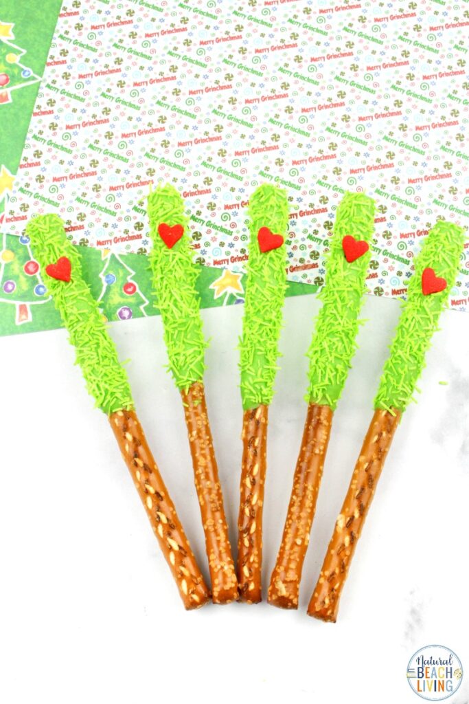 These delicious Grinch Chocolate Covered Pretzels will make everyone happy. They are so easy to make and Grinch Food Recipes look great on a party table. Add these Grinch Chocolate Covered Pretzels to your Grinch Food list and pull off a marvelous movie night or holiday party, Chocolate dipped pretzels, Grinch Party Ideas