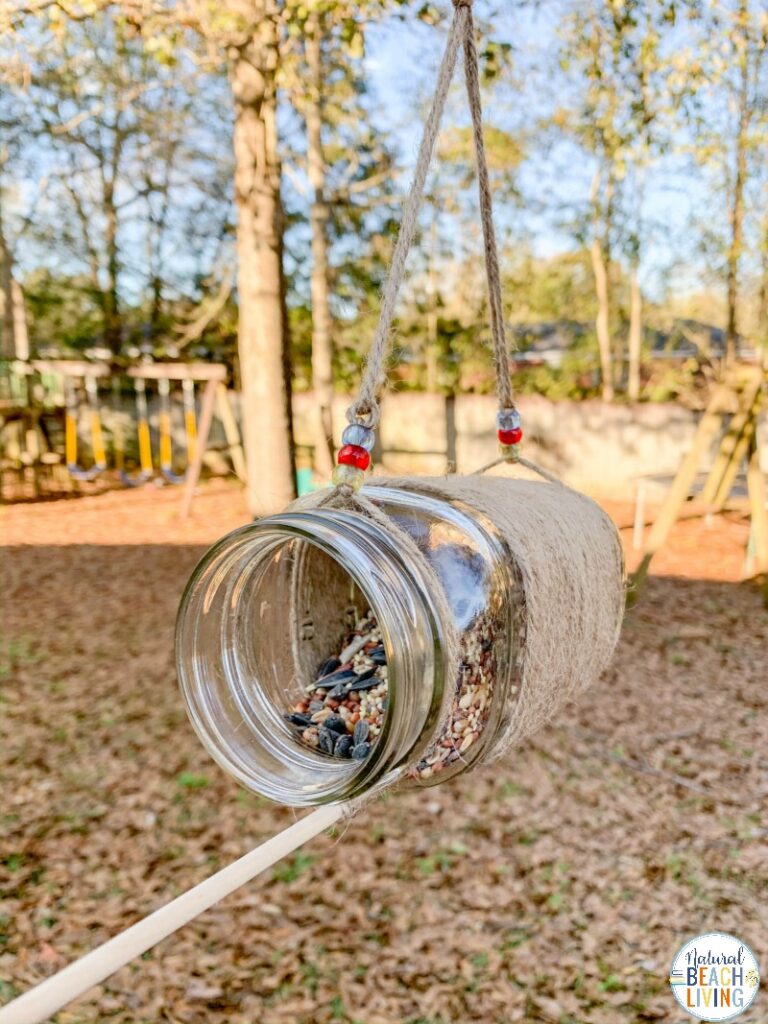 This Mason Jar Bird Feeder is a great idea for a simple and fun craft that is perfect for all ages! Whether you are looking for an activity for Earth Day, spring, summer, fall or winter homemade bird feeders are perfect for learning about birds and helping your feathered friends find food. We have THE BEST BIRD SEED ORNAMENTS and HOMEMADE BIRD FEEDERS Here